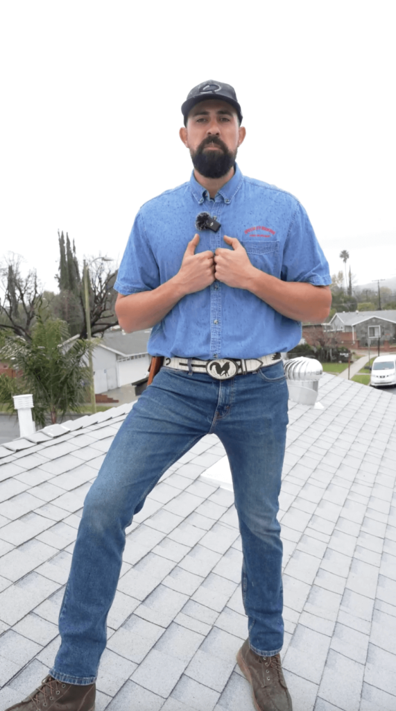 Professional roofer from SpecialtyRoofing standing on shingle roof in Los Angeles, showcasing team expertise and high-quality work